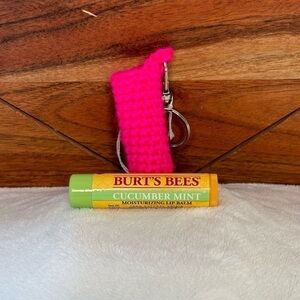 Handmade crocheted keychain lip balm case with a lip balm
